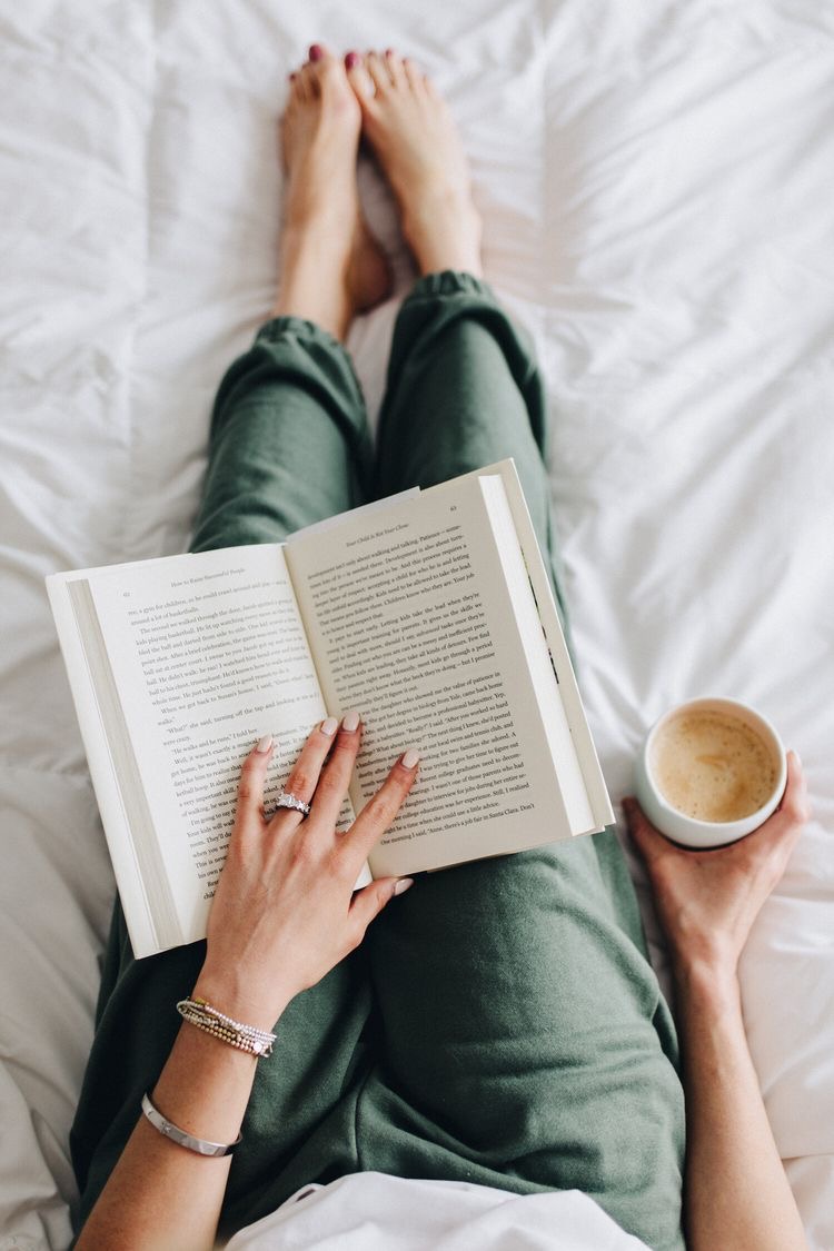 woman reading a book in bed and drinking coffee. 30 day challenge ideas. 30 days challenge ideas. 30 days challenge. challenges 30 days. month challenges. monthly challenges. monthly challenge. 30 daily challenges. month challenges.