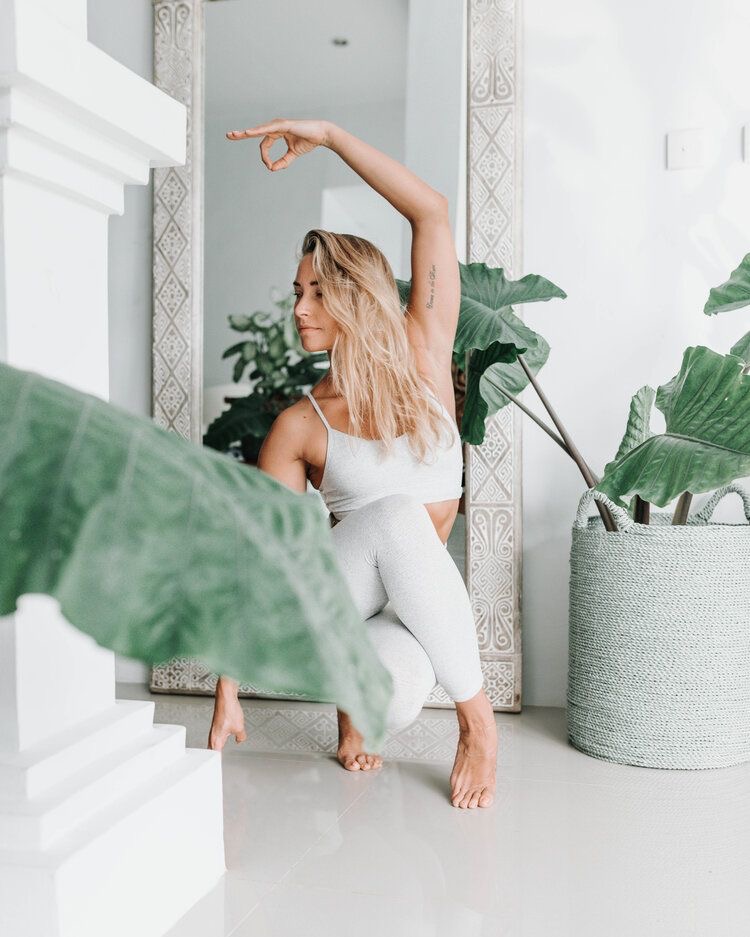 woman doing stretching and yoga poses in room with plants. 30 day challenge ideas. 30 days challenge ideas. 30 days challenge. challenges 30 days. month challenges. monthly challenges. monthly challenge. 30 daily challenges. month challenges.
