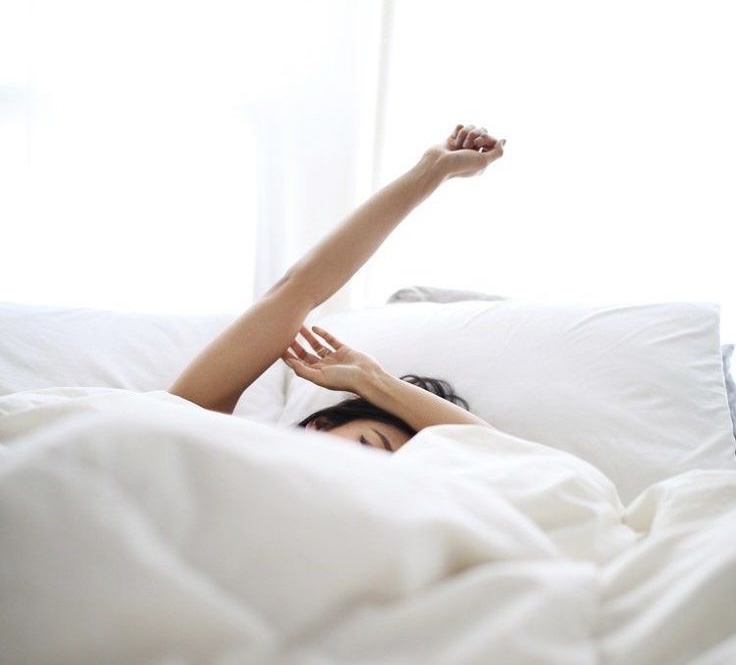 healthy living tips for a healthier lifestyle. woman waking up in bed