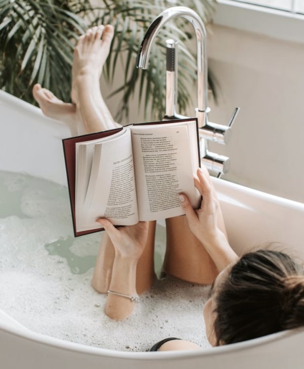 tips for a healthy lifestyle. health and wellness tips for better living. Woman reading book in the bath