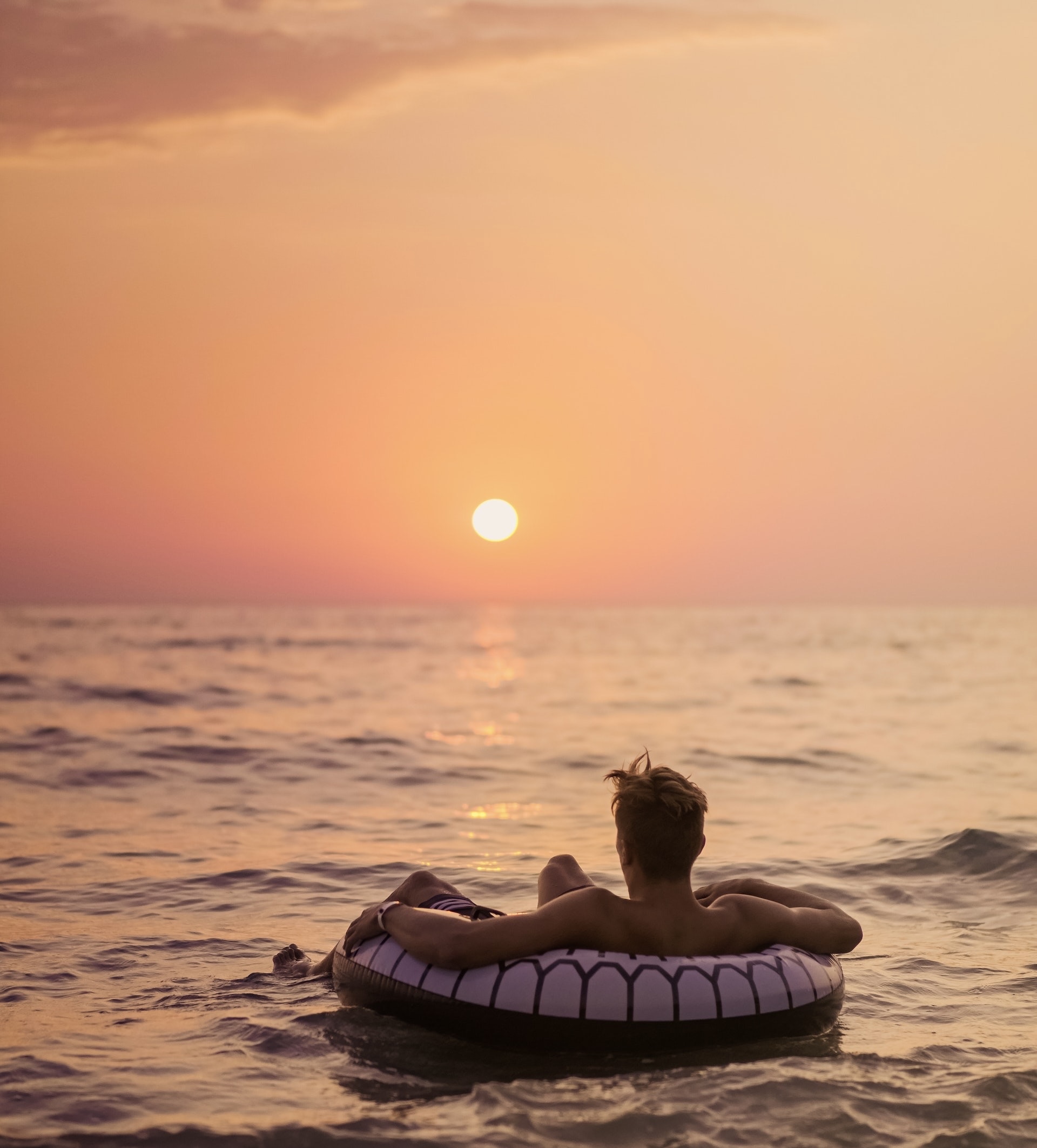 man watching a sunset on the beach. sunset in the ocean. summer inspiration. summer bucket list ideas. Fun things to do this summer. things to do in summer. things to do in the summer. things to do for summer. summer bucket lists. summer activities. activity summer. activities this summer. bucket lists for summer. bucket lists for the summer. bucket list ideas for summer. ideas for summer bucket list.