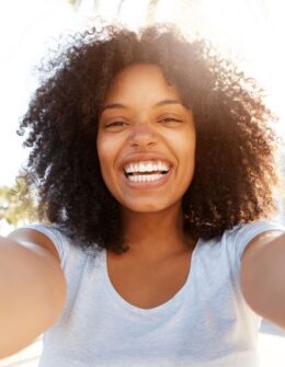 happy black woman with curly hair. how to live a life of abundance. abundant of life. living in abundance. live an abundant life. living life in abundance. abundance of life. life abundant. life in abundance. live abundantly. life abundantly. abundance living. abundant lifestyle. how to create a better life. How to be happy. how to be happier in life. how to improve your life