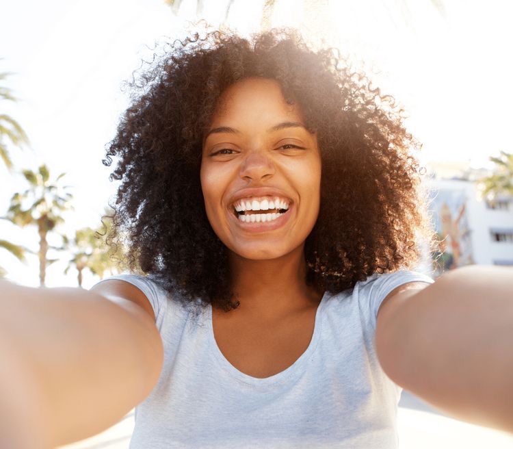 happy black woman with curly hair. how to live a life of abundance. abundant of life. living in abundance. live an abundant life. living life in abundance. abundance of life. life abundant. life in abundance. live abundantly. life abundantly. abundance living. abundant lifestyle. how to create a better life. How to be happy. how to be happier in life. how to improve your life
