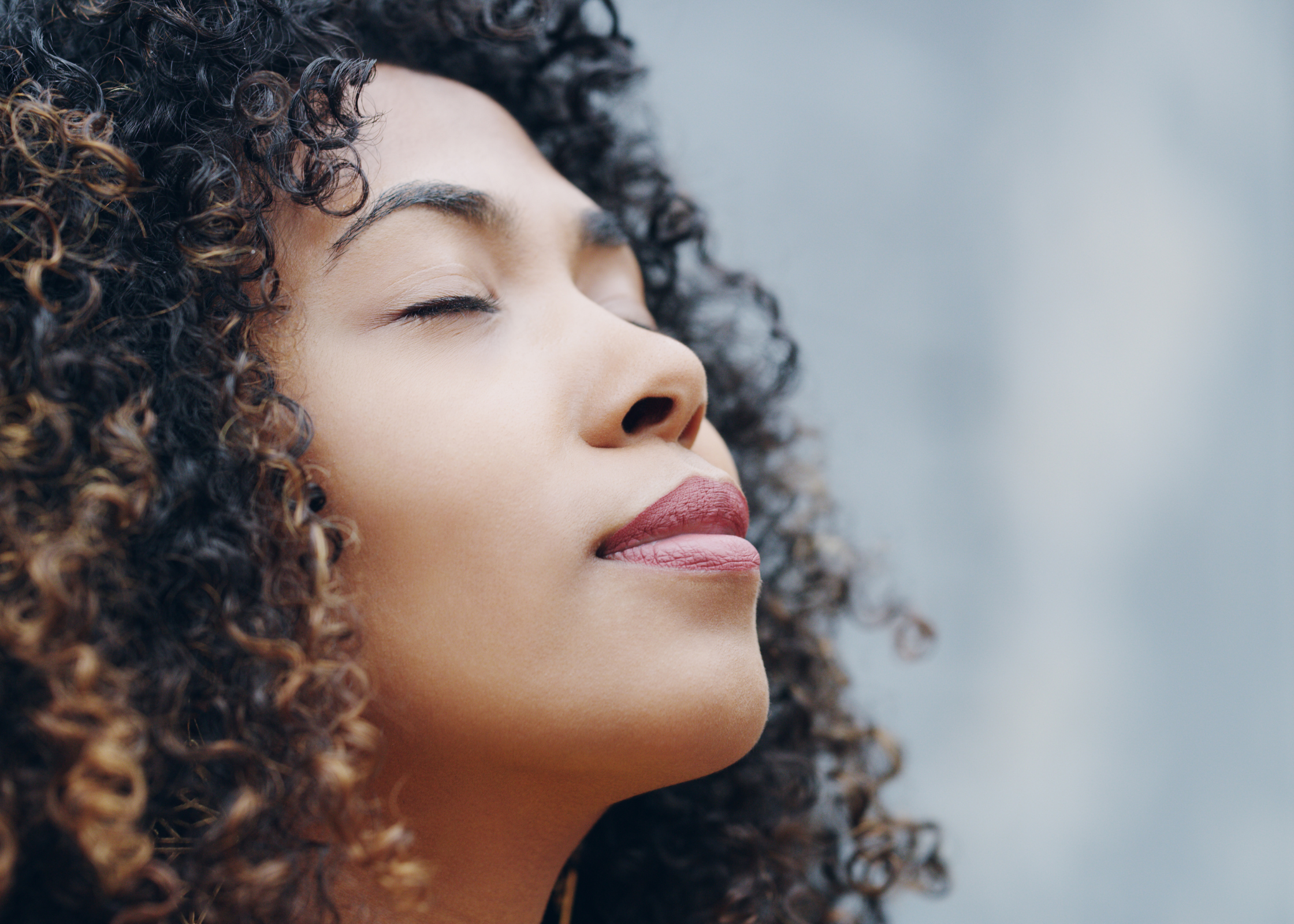 black woman breathing. Doing breathing exercises, deep breath work. relax after a long, hard, stressful day at work or at home. Ways to unwind and decompress after a busy day and relieve stress.