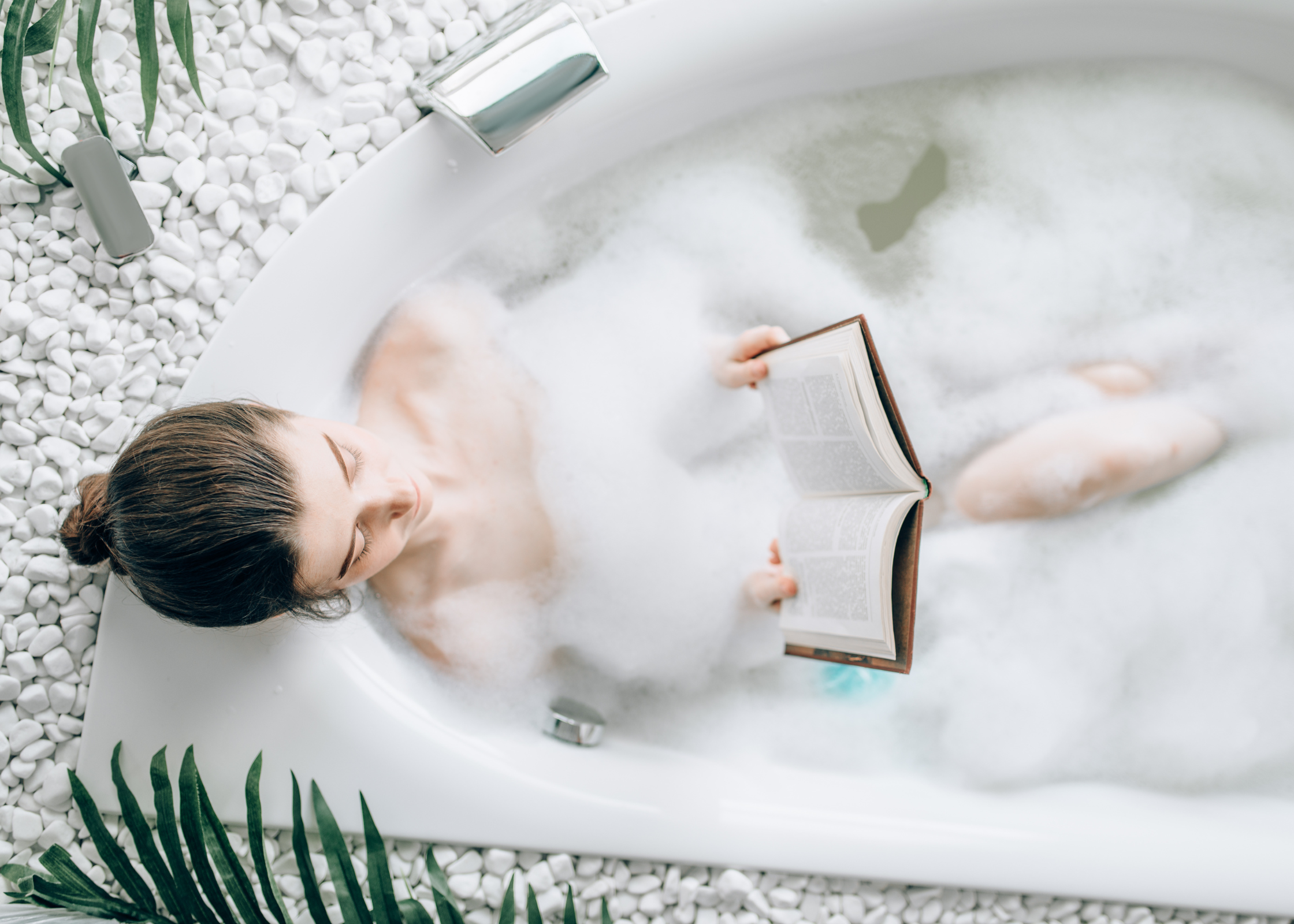 woman reading book in a bubble bath. how to glow up. glow up tips. how to glow up in a week. How to glow up overnight. how to get a glow up. how to have a glow up. glow ups. how to be beautiful. fast and instant glowing up tips