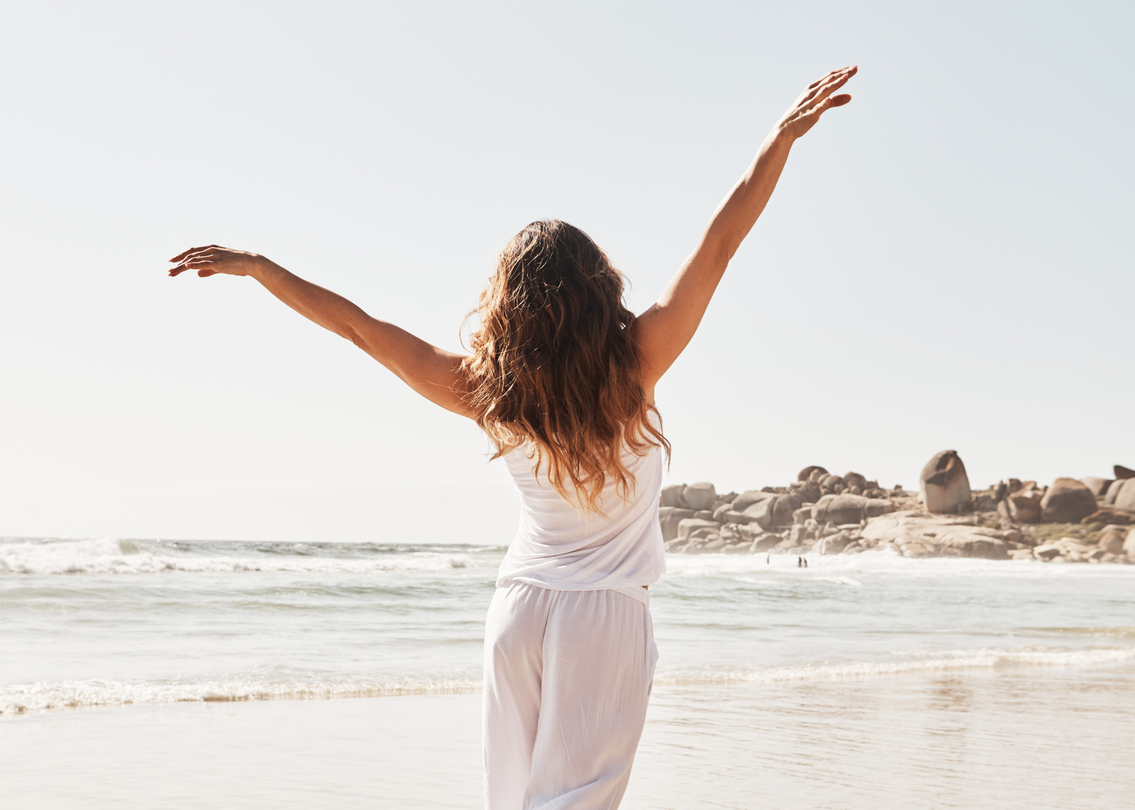 woman happy with arms out on the beach. Important life lessons to learn straight away. best life lessons. good lessons in life. life lessons quotes. life lessons to enrich your life. life lessons to help your personal development and growth