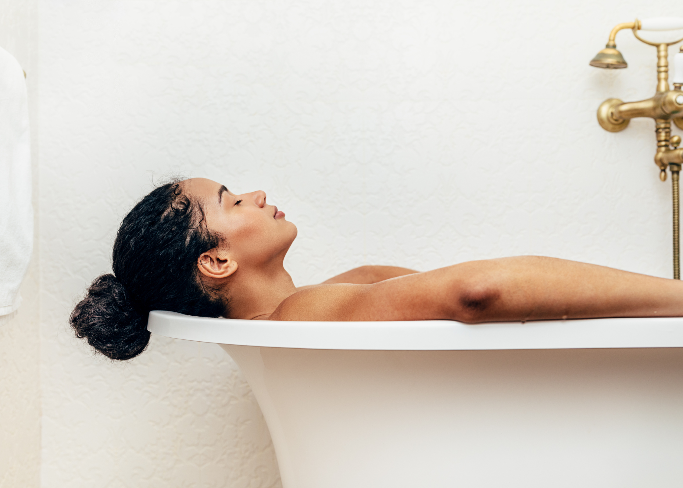 black woman taking a bath. relax after a long, hard, stressful day at work or at home. Ways to unwind and decompress after a busy day and relieve stress.