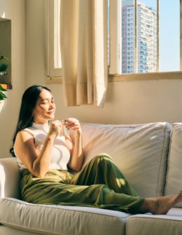 woman having a cup of tea on the sofa. relax after a long, hard, stressful day at work or at home. Ways to unwind and decompress after a busy day and relieve stress.