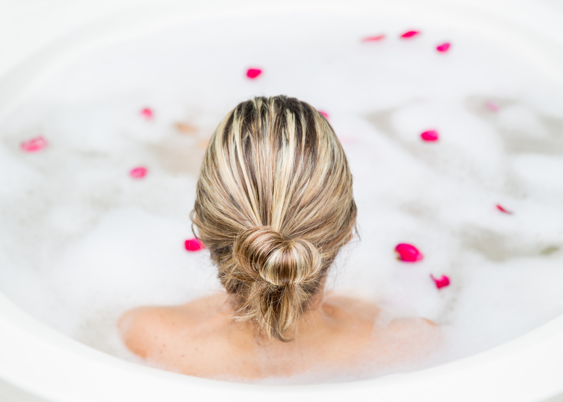 woman sitting in bubble bath with flower petals. how to take time for yourself. self care ideas for mind body and soul. self-care ideas for mental health. me time ideas