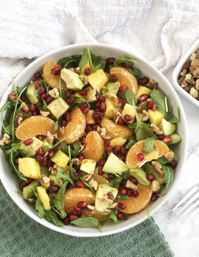 leafy watercress walnut fruit salad with avocados, pomegranates and tangerines