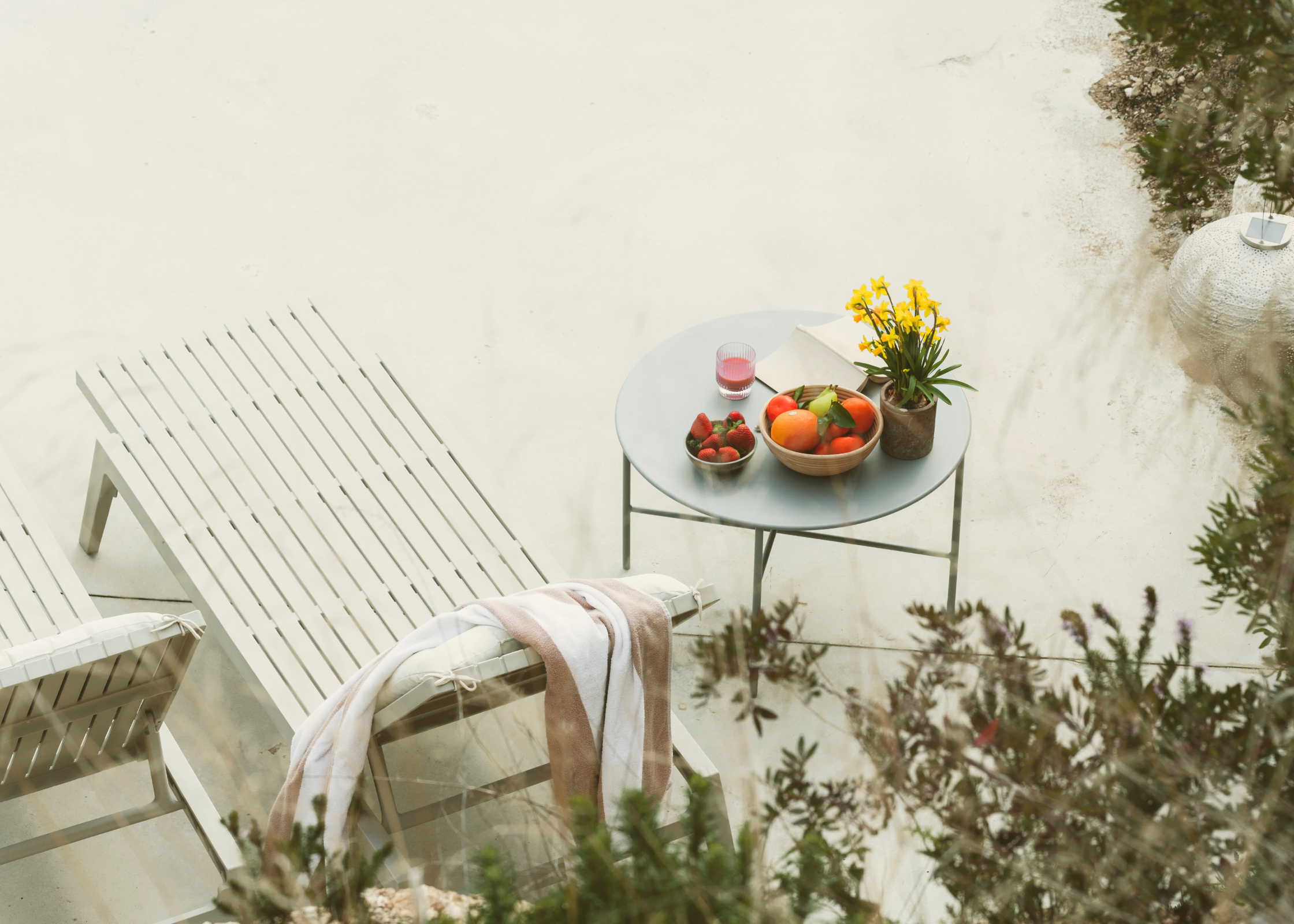 Pool chair deck with a side table of fruits and drinks. selfcare ideas for the summer. Summer self-care ideas, health and wellness tips for the summer. summer check list. Get summer ready